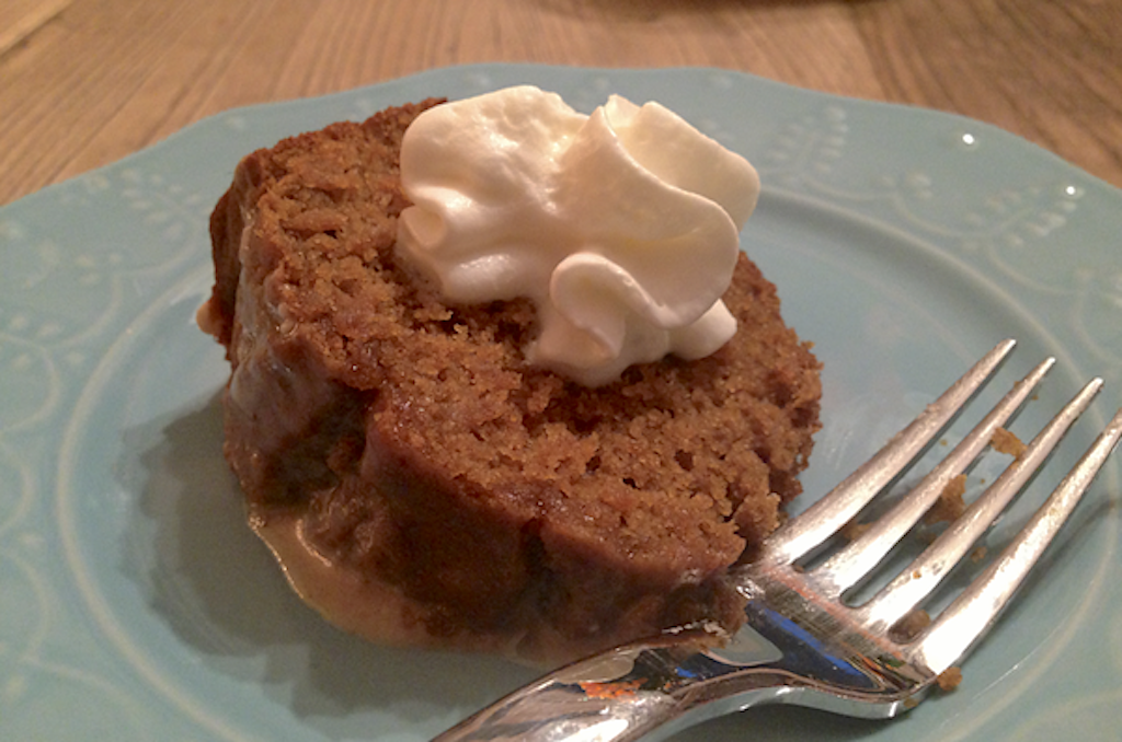gluten-free pumpkin bread slice on plate with whipped cream