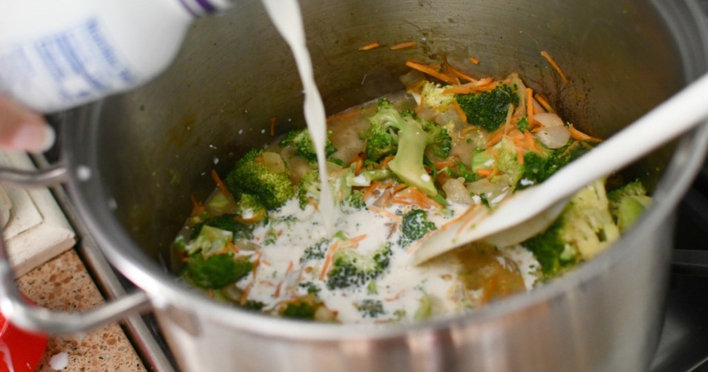 pouring half and half into broccoli cheddar soup