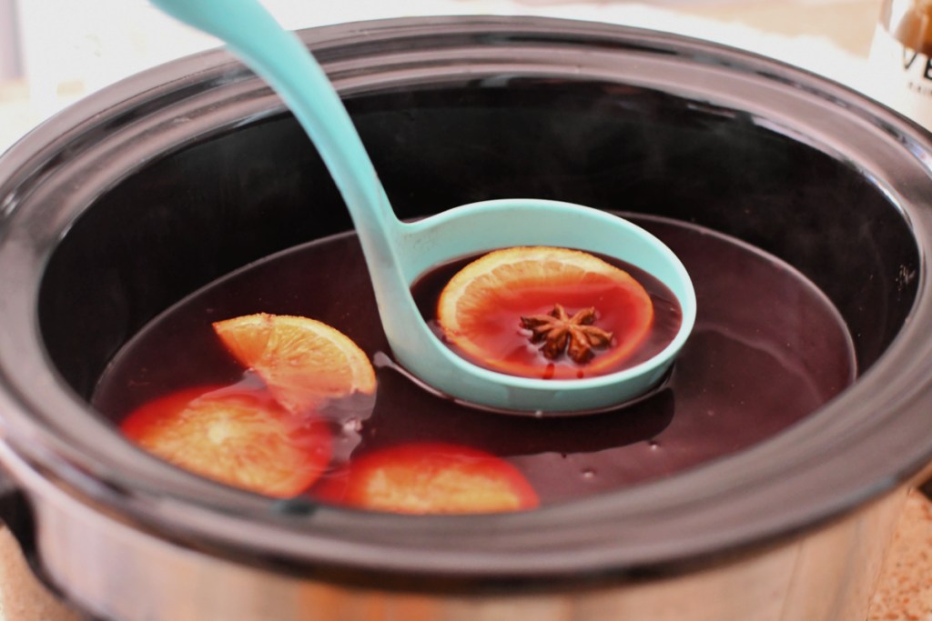 warm spiced wine in a ladle