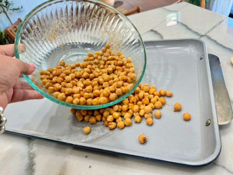 adding chickpeas to a sheet pan