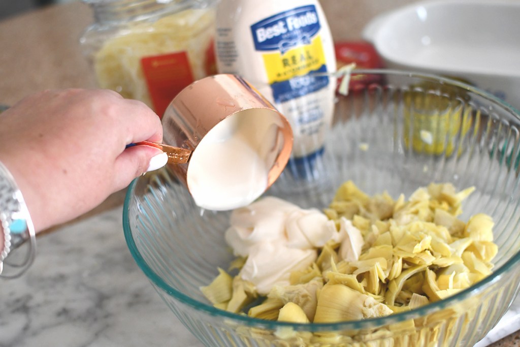 adding mayo to parmesan artichoke dip