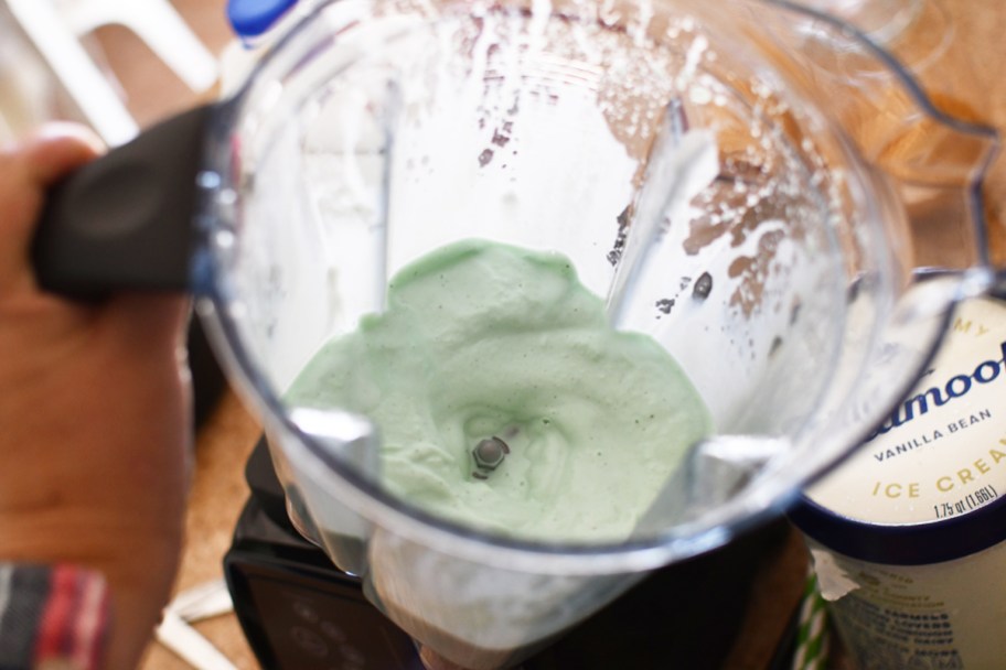 blending ice cream, peppermint extract, and milk in blender to make a copycat McDonald's Shamrock Shake