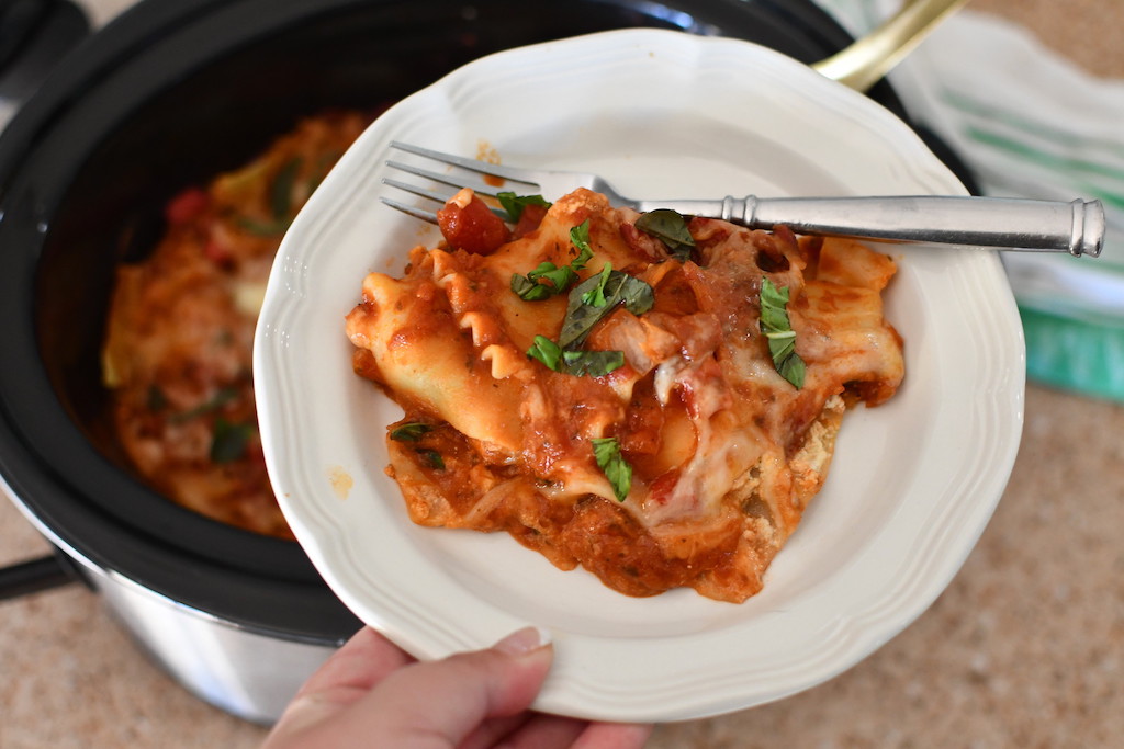 veggie lasagna on plate by slow cooker