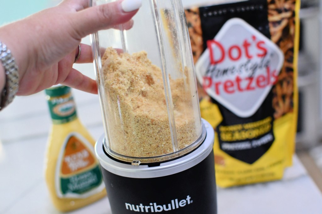 crushing pretzel crumbs in a nutribullet to bread honey mustard chicken tenders