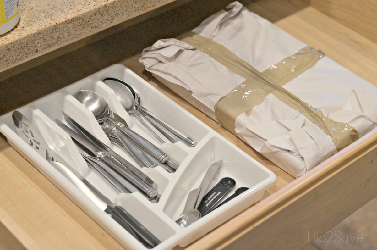 Wrap your silverware trays in paper and tape or plastic wrap