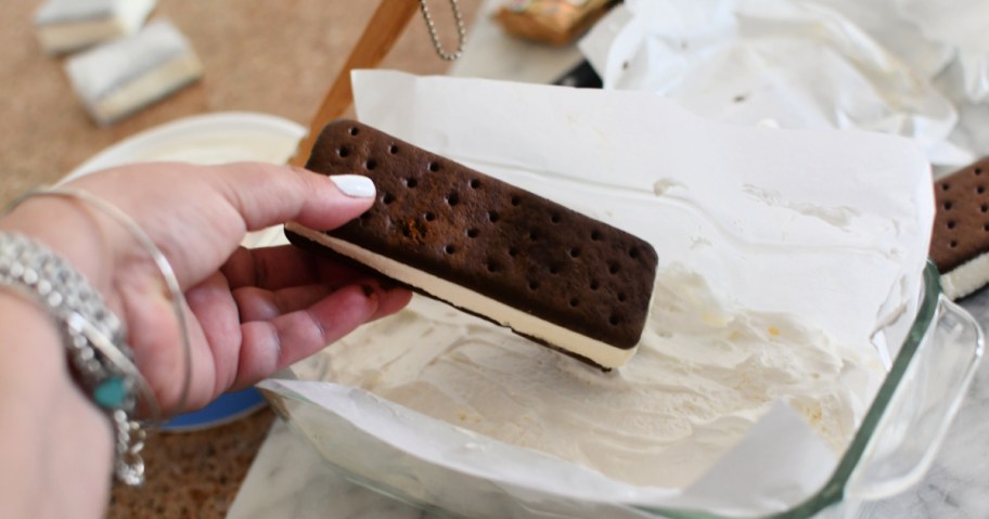 placing ice cream sandwich in loaf pan as a way to show how to make an ice cream sandwich cake