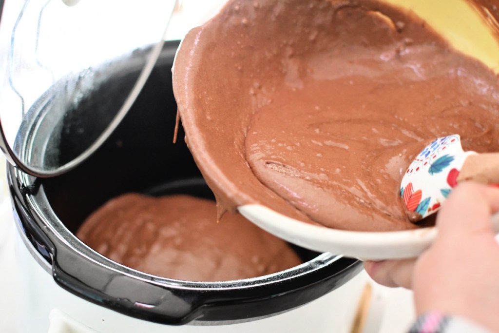 pouring chocolate lava cake into the slow cooker