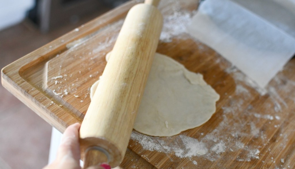 using a rolling pin to make tortillas