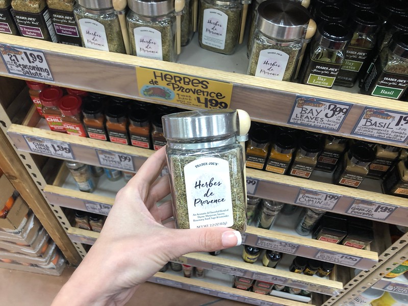 holding a jar of Herbes de Provence