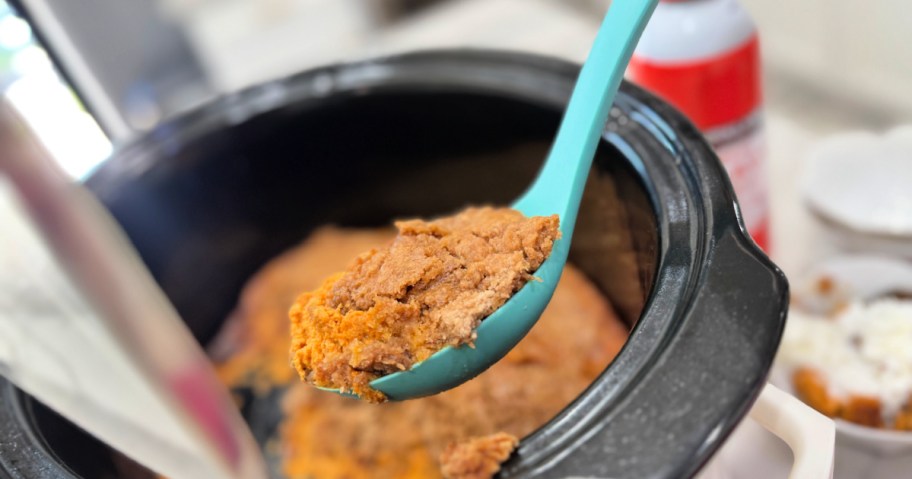 pumpkin dump cake in the slow cooker after cooking on a spoon 