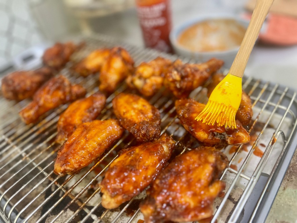 brushing on spicy chicken wings sauce