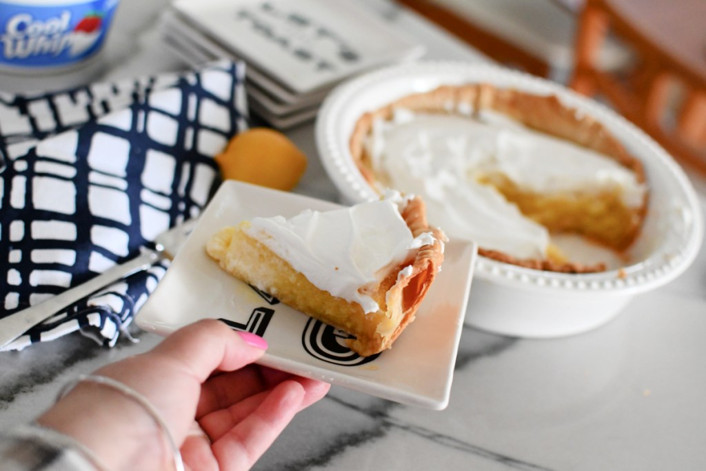 holding a slice of pie on a small plate