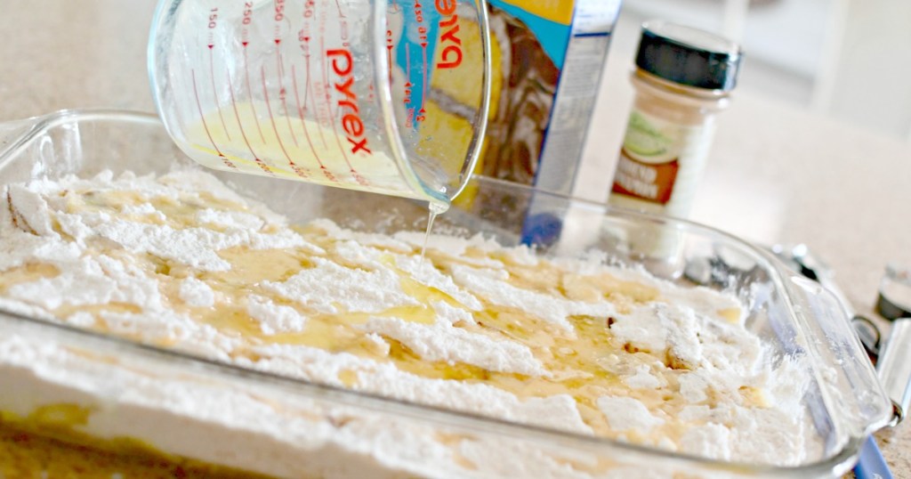 pouring melted butter over cake mix