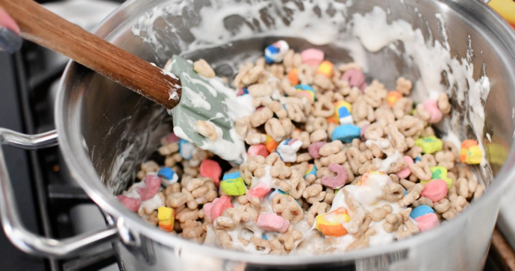 mixing lucky charms treats in pan