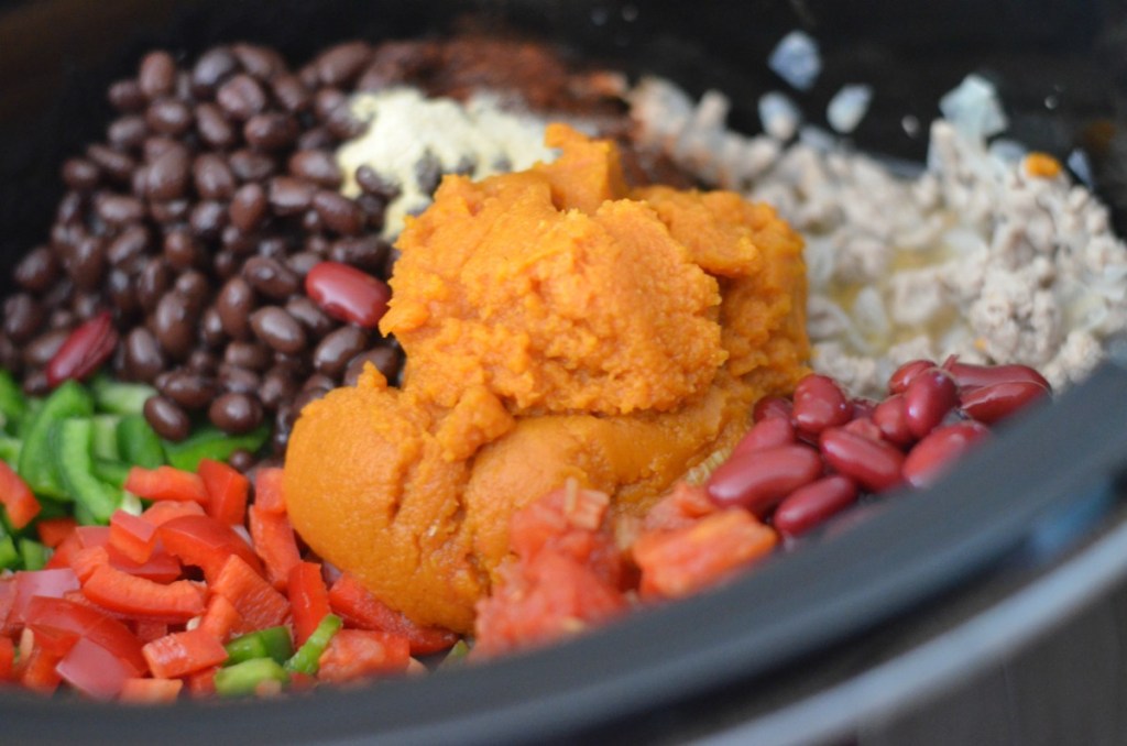 pumpkin chili ingredients in a slow cooker