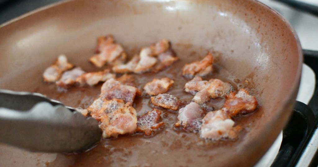 cooking bacon pieces in skillet
