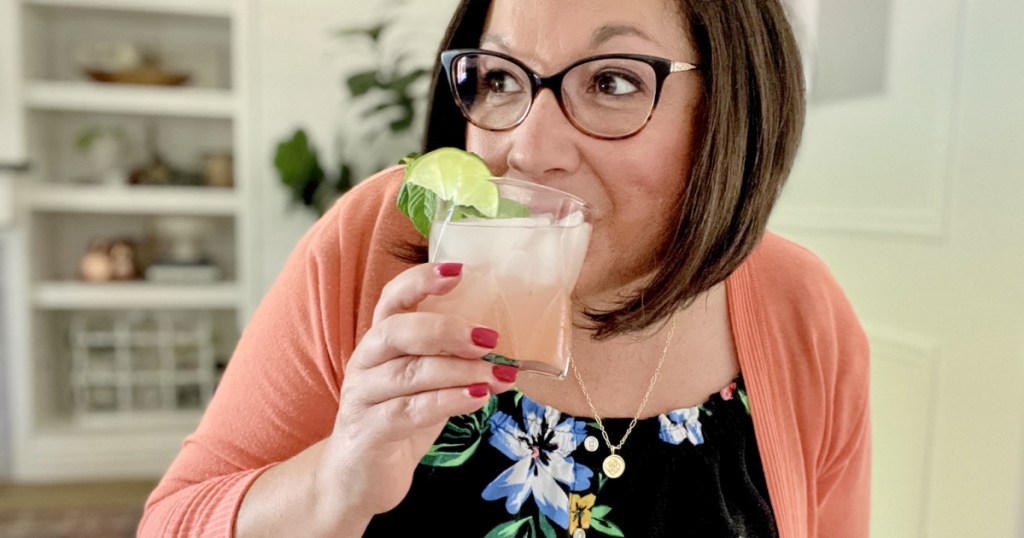 woman sipping a mocktail drink