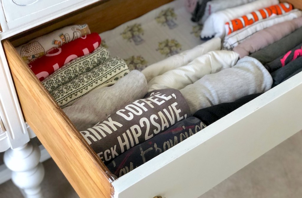 organized dresser clothing drawer with various clothes