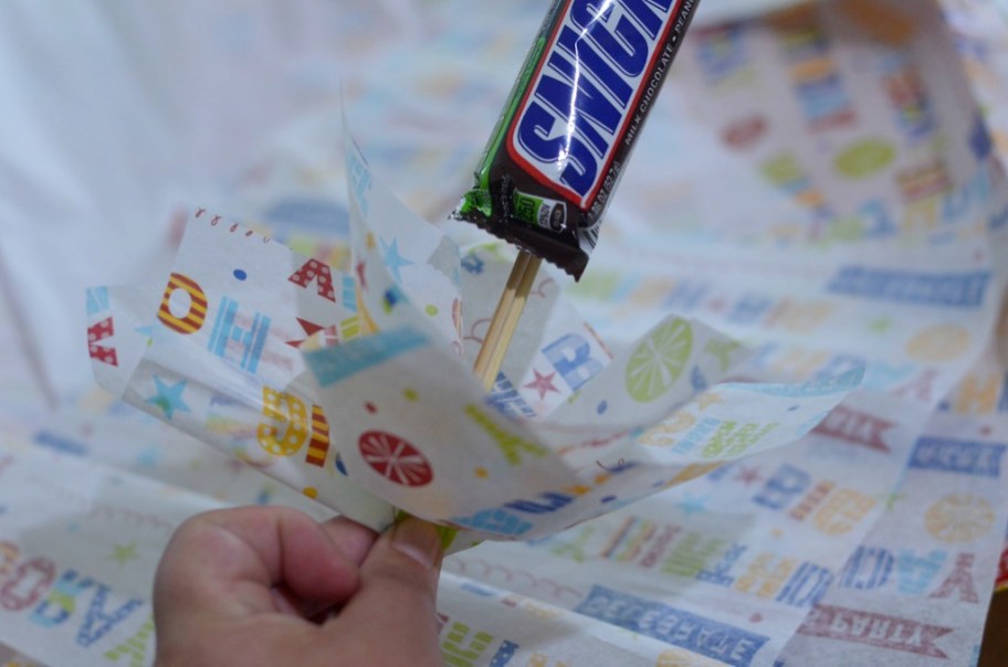 putting snickers bar in tissue paper