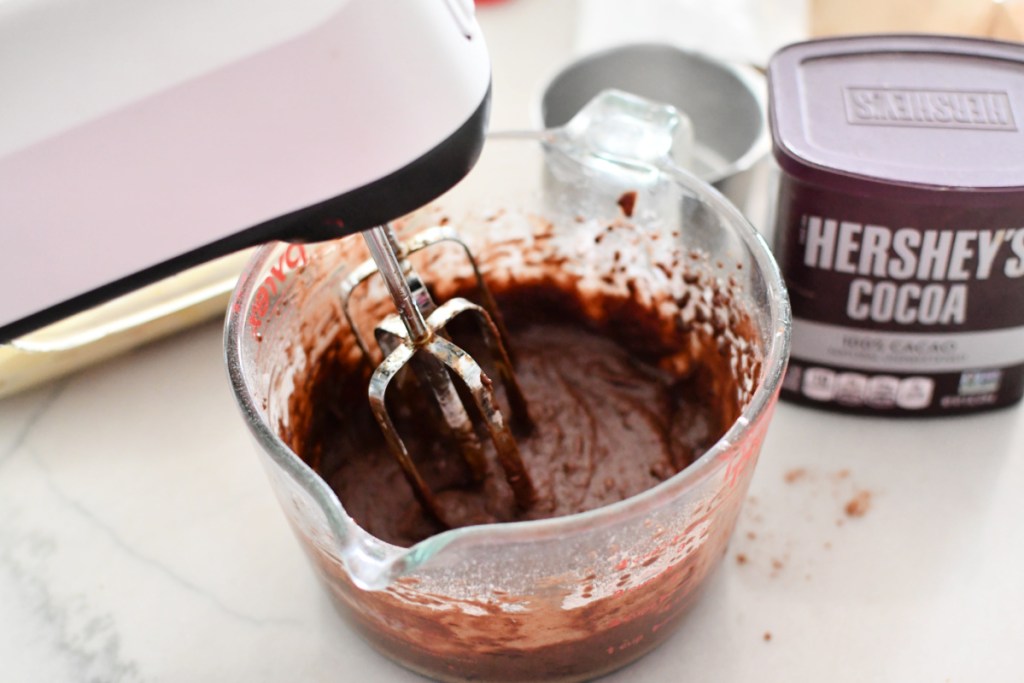 mixing chocolate eclair frosting