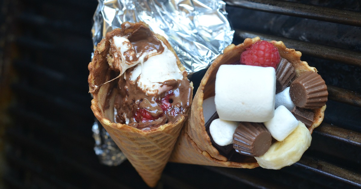 waffle cones filled with marshmallows, fruit, and candy