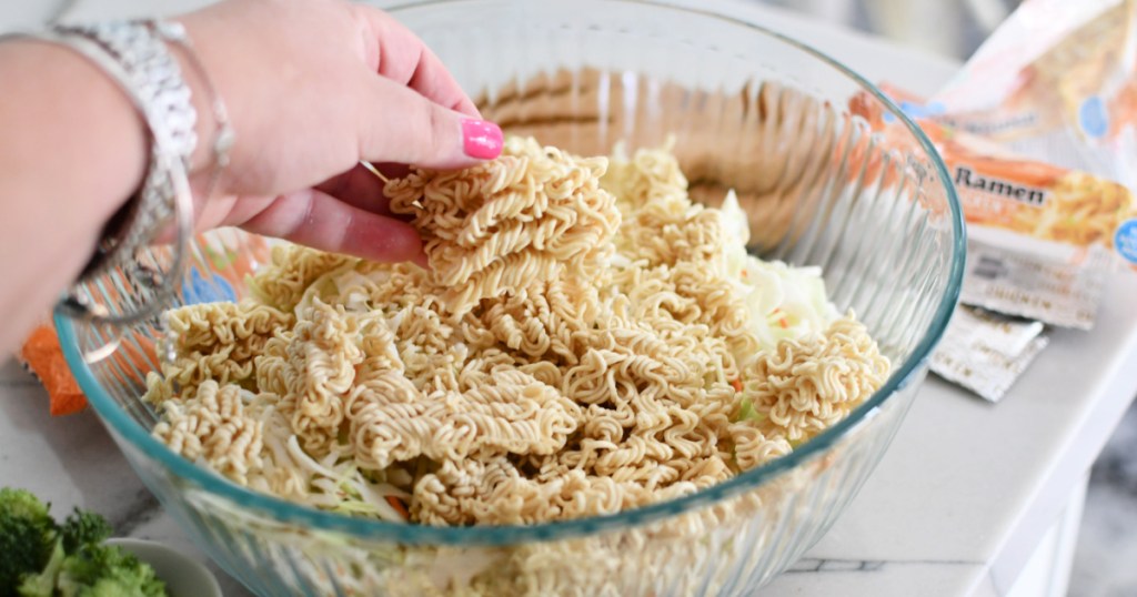adding ramen noodles to mixing bowl