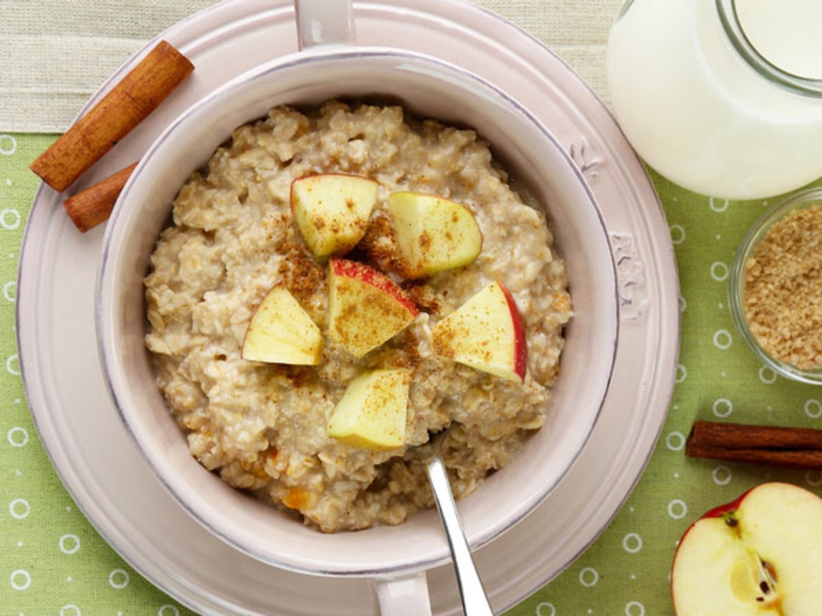 oatmeal in bowl topped with apples and cinnamon