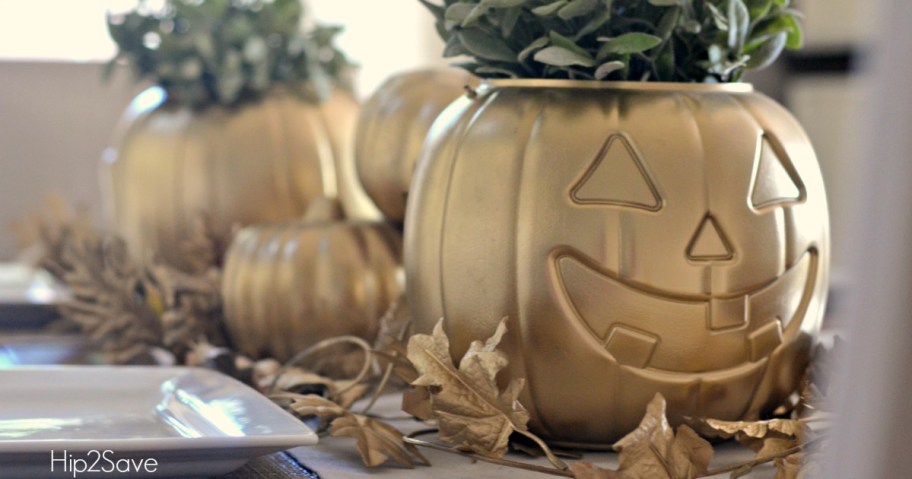 table centerpiece with plastic pumpkins spray painted in gold