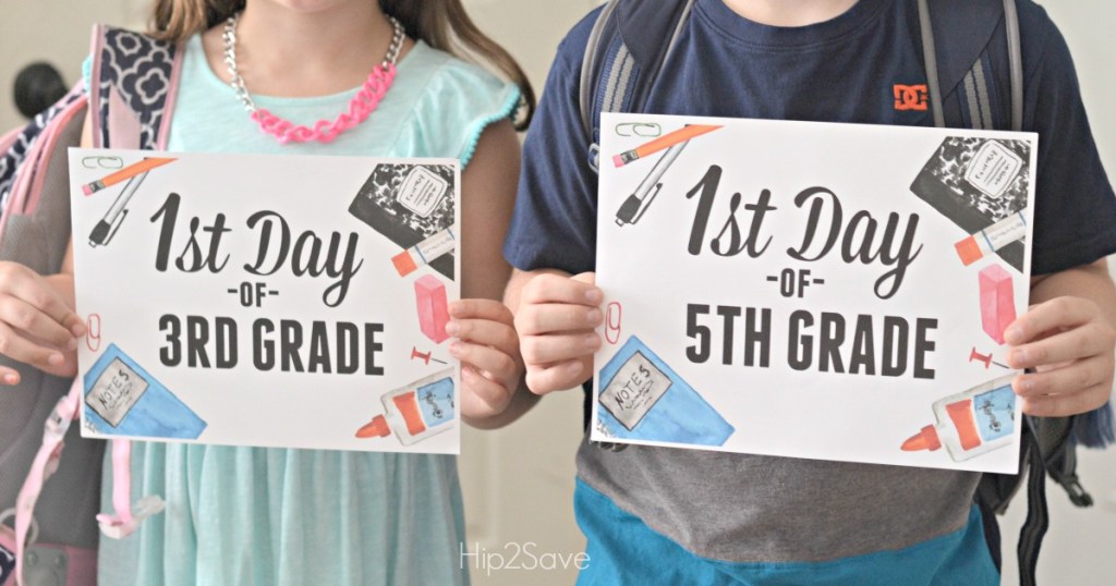 FREE Printable First Day of School Signs held by two kids