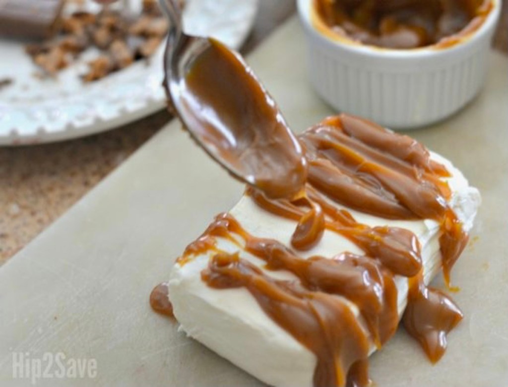 drizzling caramel on a bar of cream cheese
