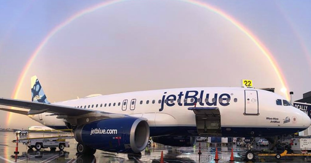 jet blue plane under rainbow