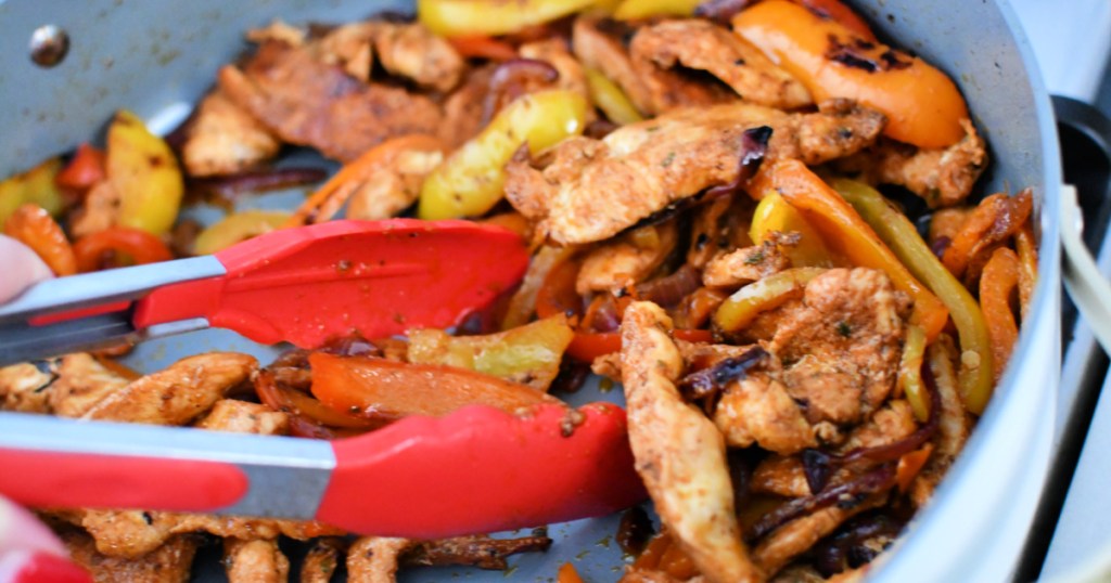 using tongs to dish up fajitas