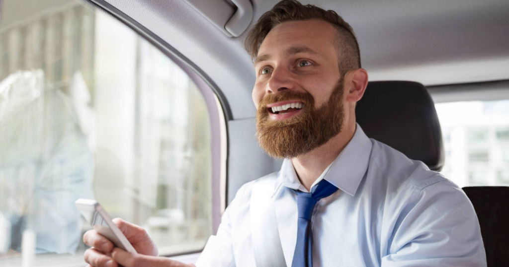 man smiling in uber car 