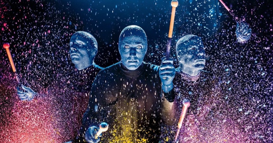 Blue Man Group performing with paints