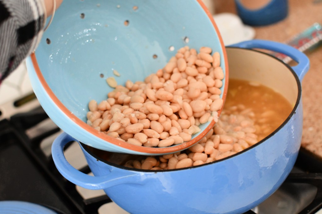 adding beans to soup