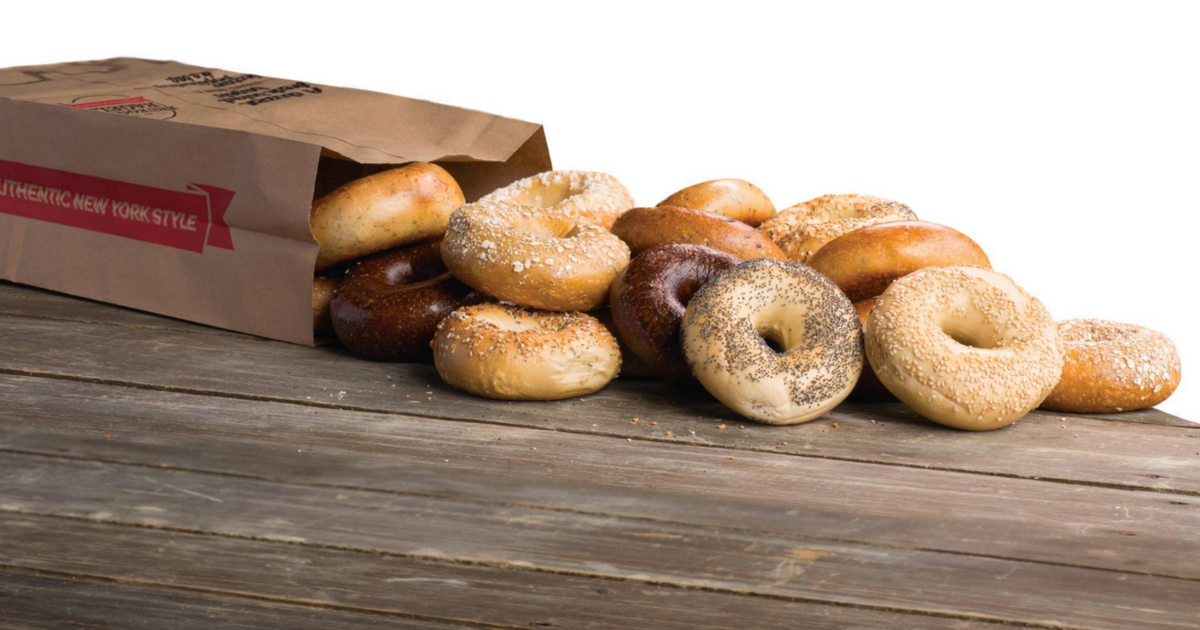 Brueggers Bagels spilling out of a brown paper sack