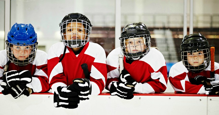 Kids wearing hocky gear.