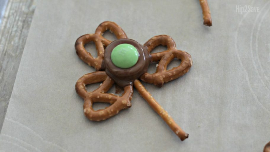 finishing making shamrock snacks by adding the M&M to the rolo 