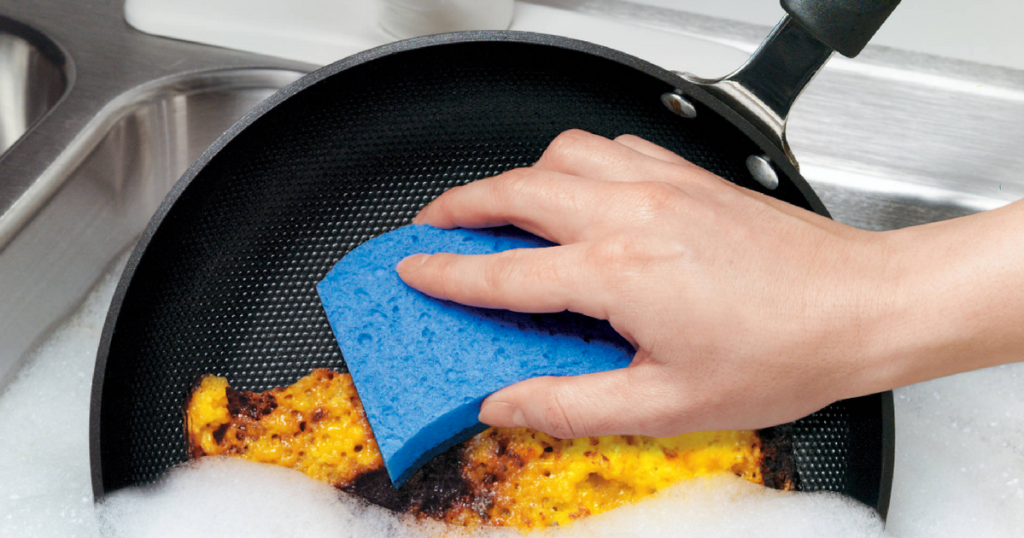Scotch-Brite Non-Scratch Scrub Sponge cleaning a pan in soapy water
