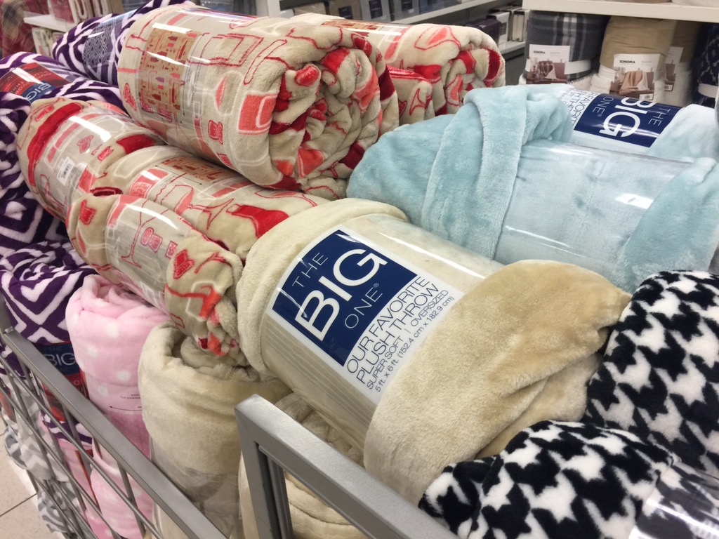 Kohl's bin full of The Big One Throws in a variety of patterns