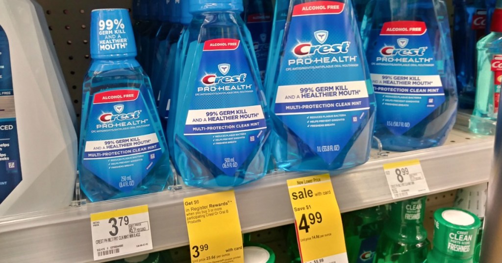 A row of Crest mouthwashes lined up on Walgreens shelf with sale tags