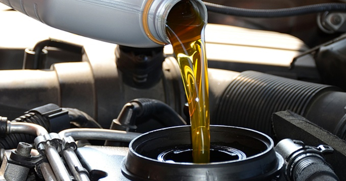 pouring oil into a car