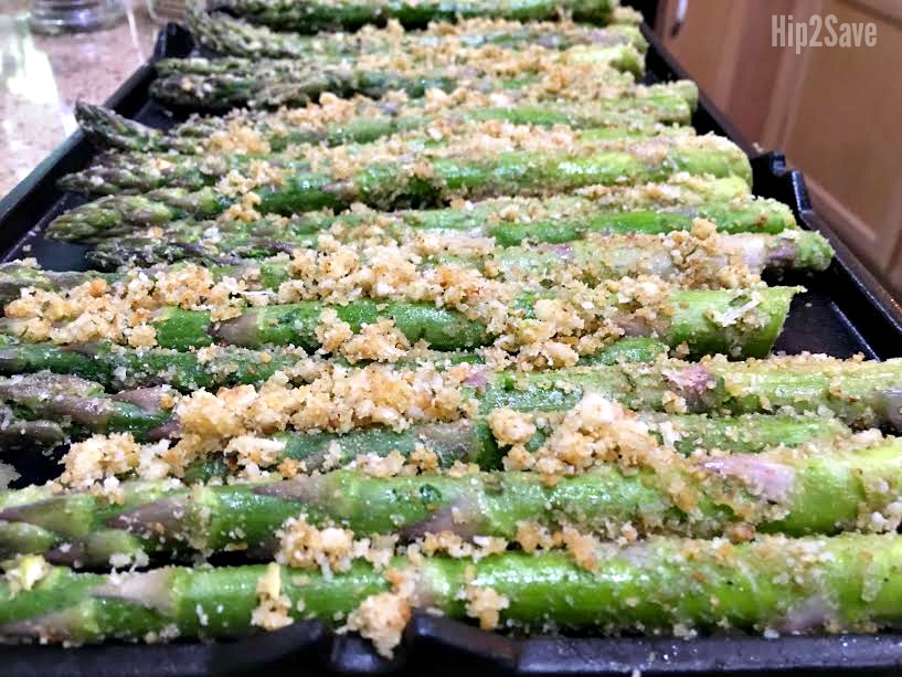 arranging the roasted asparagus on a tray for grilling