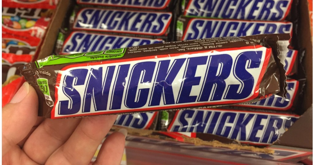 hand holding snickers candy bar 