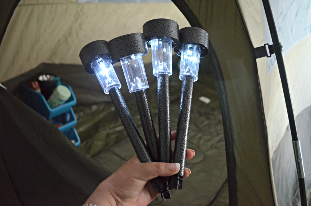 camping hacks - solar stake lights in front of camping tent