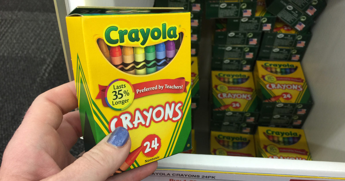 holding a box of Crayola crayons