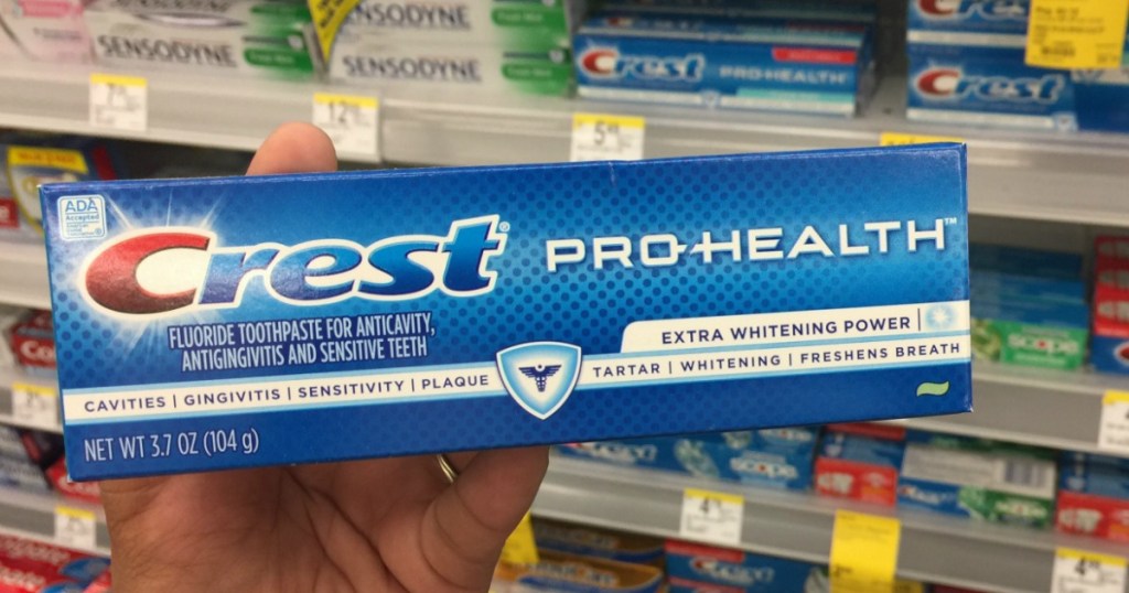hand holding crest pro health toothpaste in store
