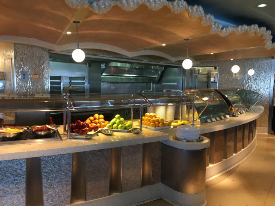 cruise buffet line with fresh fruits, which you should skip on your first day when you plan a cruise