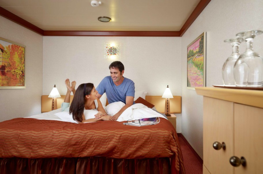 couple sitting on bed in cruise room