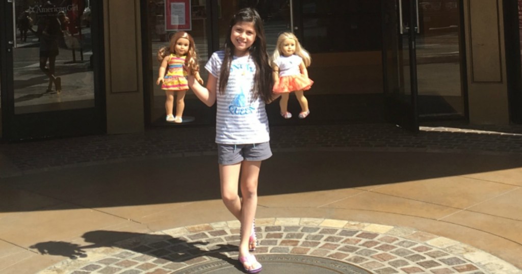 girlholding two american girl dolls 